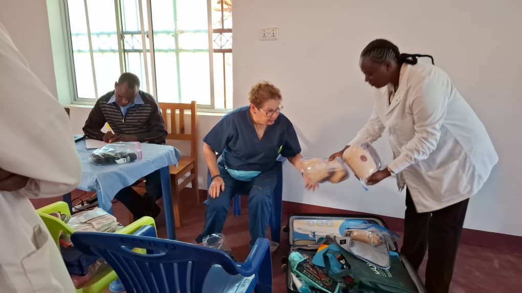 Dr. Teressa sharing donated medical supplies with the Lake Eyasi health care team